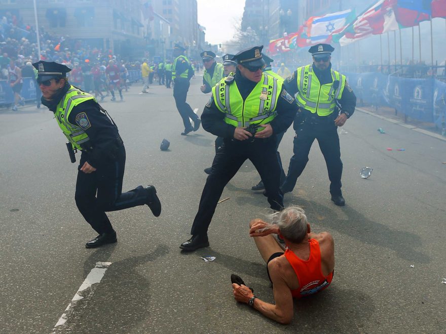 April 15, 2013. Boston police officers react to a second explosion near the finish line of the 117th Boston Marathon. Credit: John Tlumacki - Boston Globe