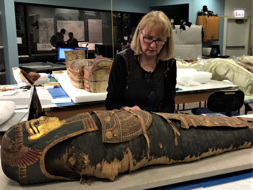 Conservator Mimi Leveque examines mummy in Field Museum